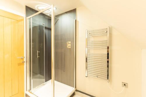 a shower in a bathroom with a glass door at Marian Resort And Spa in Prestatyn