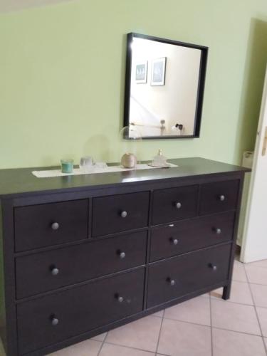 a bathroom with a sink and a mirror at la mansarda nel bosco in Tolfa