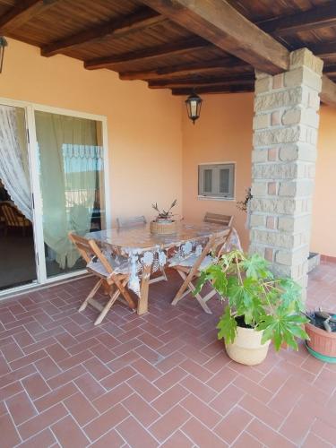 a table and chairs sitting on a patio at la mansarda nel bosco in Tolfa