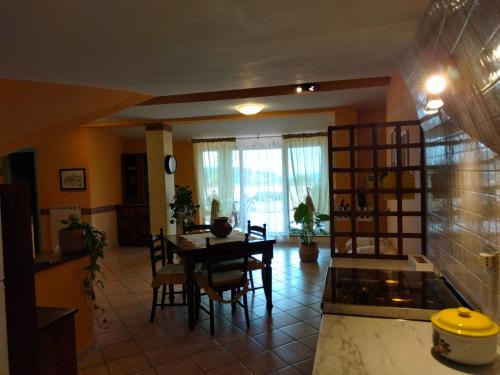 a kitchen and dining room with a table and chairs at la mansarda nel bosco in Tolfa