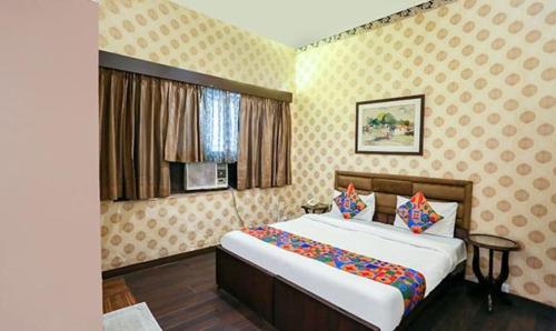ein Schlafzimmer mit einem großen Bett in einem Zimmer in der Unterkunft FabExpress Pulse Impulse in Neu-Delhi