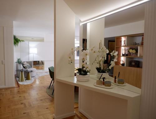 a living room with a table and a mirror at Porto Family Home by MP - Renovated in Porto