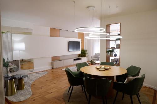 a dining room with a table and green chairs at Porto Family Home by MP - Renovated in Porto