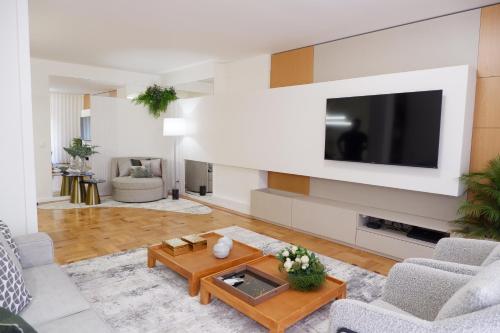 a living room with a tv on a wall at Porto Family Home by MP - Renovated in Porto