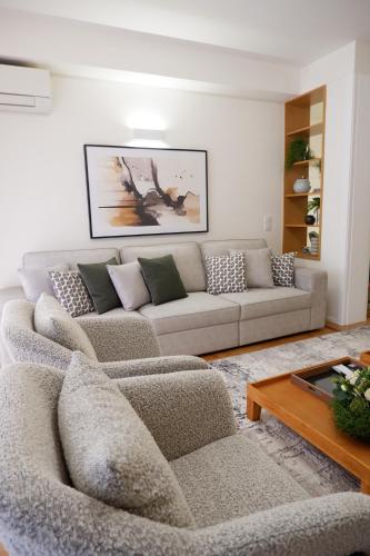 a living room with a couch and a coffee table at Porto Family Home by MP - Renovated in Porto