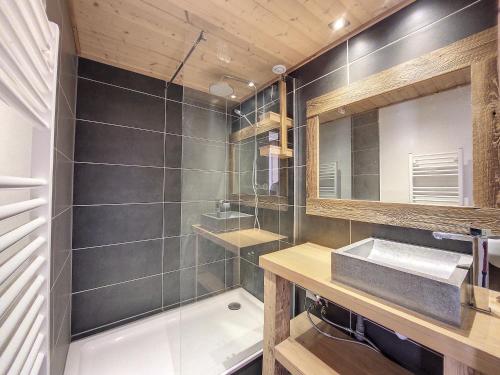 een badkamer met een wastafel en een spiegel bij la ranche in Montriond