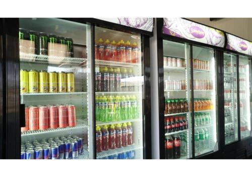 a store refrigerator filled with lots of sodas and drinks at SleepOver Upington in Upington