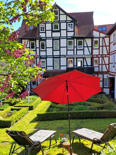 a red umbrella in front of a house at Haus Lieberum in Bad Sooden-Allendorf