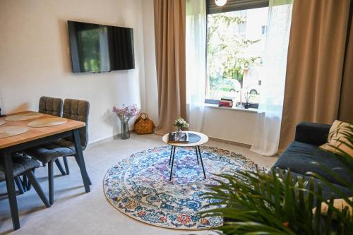 a living room with a table and a couch at 4-star Design Apartments Bubamara in Zadar