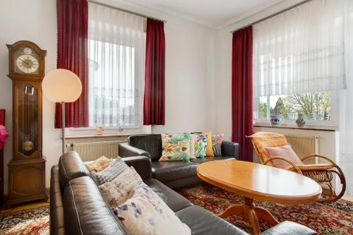 a living room with a couch and a table at Siravit Am See in Friedrichshafen