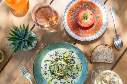 a table with plates of food and glasses of wine at Château Mentone in Masseboeuf