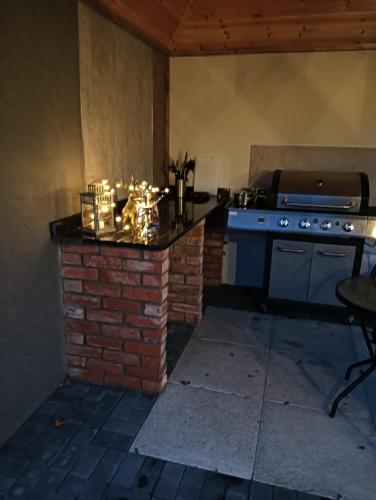 a kitchen with a stove and a brick fireplace at Lucker mill shepherds huts in Lucker