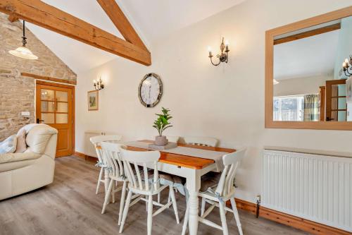 a kitchen and dining room with a table and chairs at Starling cottage in Pickering