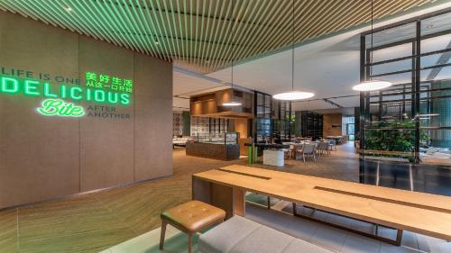 a lobby with a table and chairs in a building at EVEN Hotel Yinchuan Yuehai by IHG in Yinchuan
