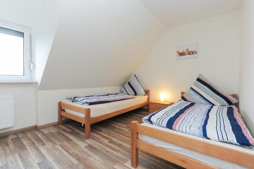 Postel nebo postele na pokoji v ubytování Ferienhaus Windlicht