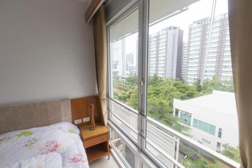 a bedroom with a bed and a large window at Condo I -House Laguna Garden RCA - Outer CBD in Bangkok