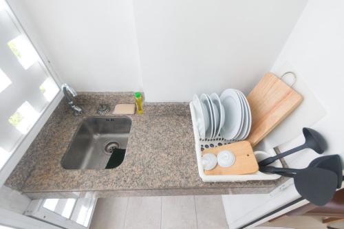 a kitchen counter with a sink and some dishes at Condo I -House Laguna Garden RCA - Behind Sukhumvit-Outer CBD in Bangkok