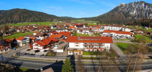 a town with orange roofs and a mountain in the background at Alpenhotel Gastager in Inzell