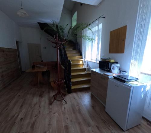 a living room with a staircase and a stair case at Gospodarstwo u Krakusa in Doboszowice