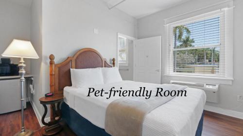 a bedroom with a bed in a room with a window at Crystal Bay Historic Hotel in St Petersburg