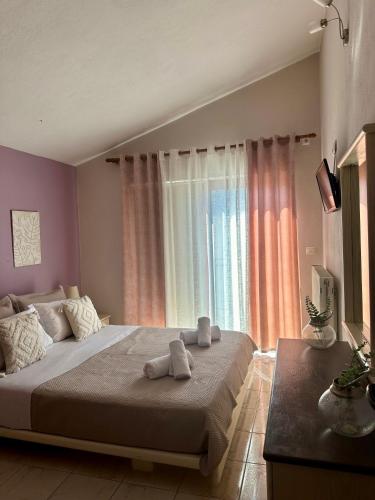 a bedroom with a large bed with towels on it at Christina's Home in Skiathos Town