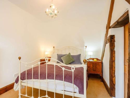 a bedroom with a white bed and a chandelier at 4 Bed in Corwen 88868 in Corwen