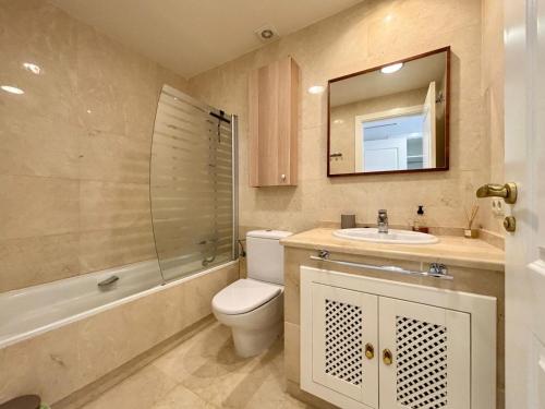 a bathroom with a toilet and a sink and a mirror at Casa Del Sol by Rental Hero in San Javier