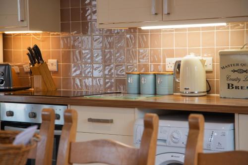 a kitchen with a counter top with a coffee maker at Dale Cottage in Telford