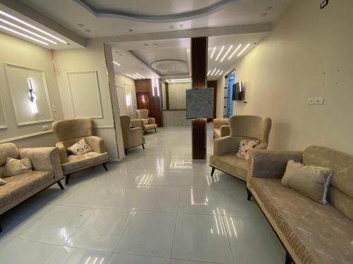 a waiting room with couches and chairs in a building at Explore Stars Pyramids View in Cairo