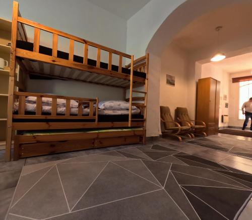 a room with two bunk beds and a tile floor at Loft w centrum Złotego Stoku in Złoty Stok