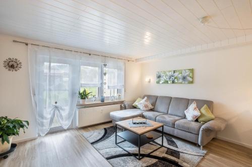 a living room with a couch and a table at Ferienwohnung Odenwald in Wald-Michelbach
