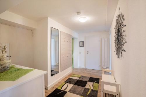 a room with a hallway with a mirror and a stool at Ferienwohnung Odenwald in Wald-Michelbach