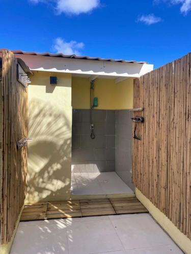 a bathroom with a shower with a wooden fence at 21 Villa Chuchubi in Kralendijk