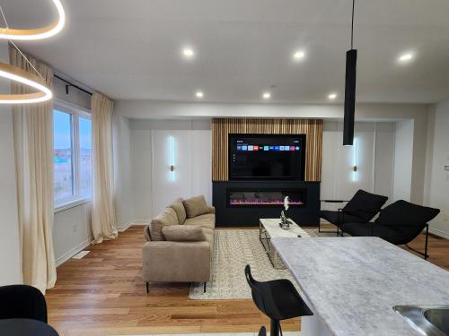 a living room with a couch and a table at Exclusive Home in Niagara Falls in Thorold