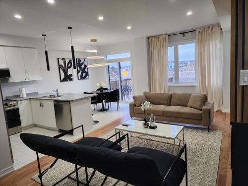 a living room with a couch and a table at Exclusive Home in Niagara Falls in Thorold