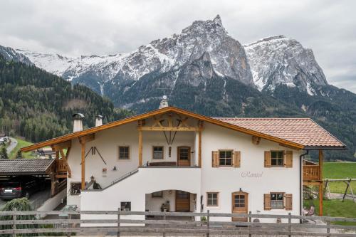 a house with a mountain in the background at Ronsolhof Ortler in Siusi