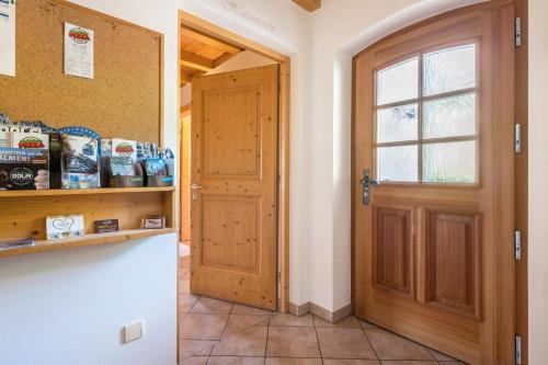 a kitchen with a door and a counter with food at Ronsolhof Ortler in Siusi