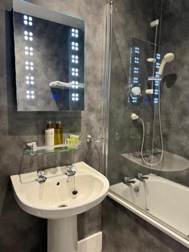 a bathroom with a sink and a shower and a tub at Lochranza Country Inn in Lochranza