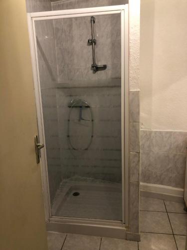 a shower with a glass door in a bathroom at Appartement 4 pers in Aiglun