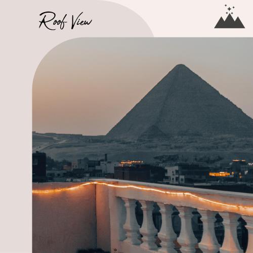 a view of the pyramids from the balcony of a building at Explore Stars Pyramids View in Cairo
