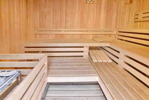 a wooden sauna with four beds in it at Obok Lasu in Grebiszew