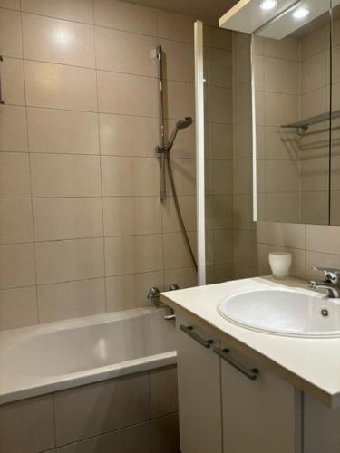 uma casa de banho com um lavatório e uma banheira em Walter Vilain 0503 - 5 min De La Plage em Koksijde
