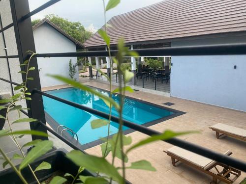 a swimming pool in front of a house at Lion Gate Hotel Sigiriya in Sigiriya