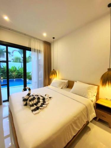 Ένα ή περισσότερα κρεβάτια σε δωμάτιο στο Cosy 2bed/2bath villa 5 min to beach