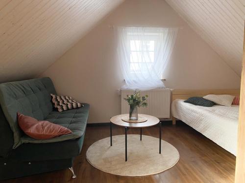 a living room with a couch and a table at Trakų Namelis in Trakai