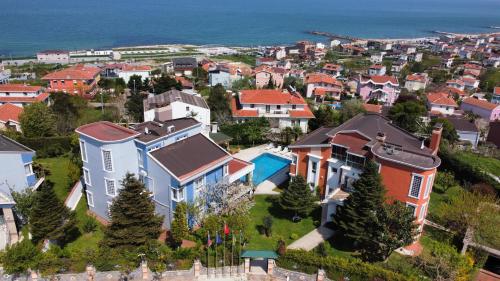 an aerial view of a city with houses and the ocean at WHITE MANSION in Arnavutköy