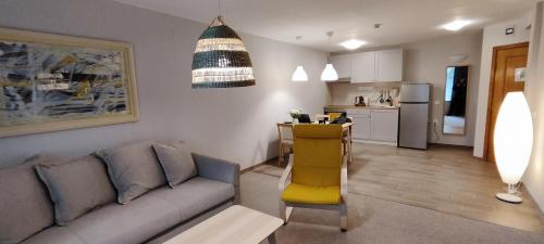 a living room with a couch and a kitchen at Hostel Elena in Sofia