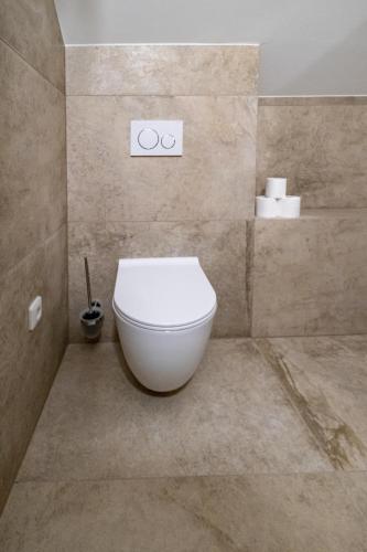 a bathroom with a white toilet in a room at Relax Hotel Stork in Lednice