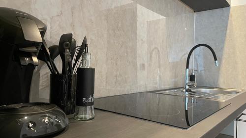 a kitchen counter with a sink and aaucet at Gallery Apartment in Bonn