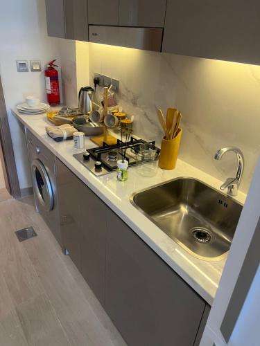 a kitchen with a sink and a counter top at Luxury Studio Brand New with HighEnd Furnishings in Dubai
